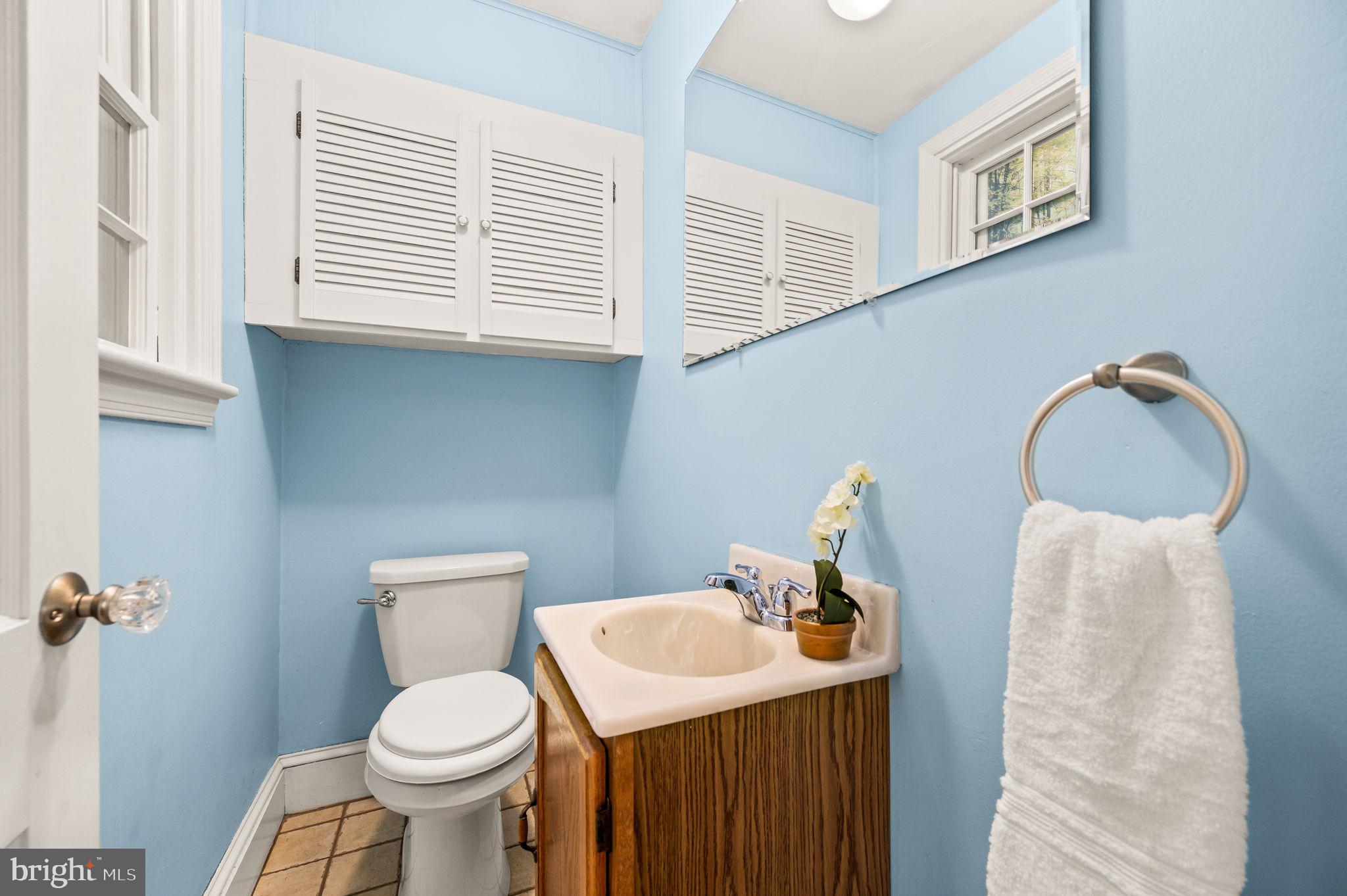 101 East Rose Valley Road Wallingford, PA 19086 - Photo 8 of 38 a bathroom with a toilet sink and mirror