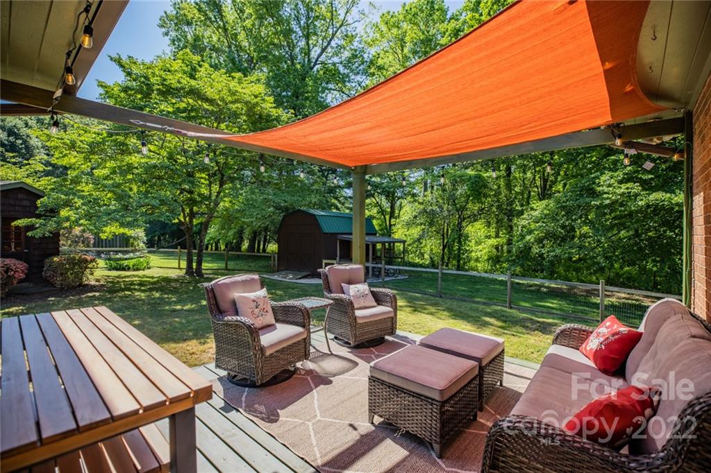 171 Orchard Road Statesville, NC 28677 - Photo 18 of 46 a view of a patio with couches chairs potted plants and a palm tree
