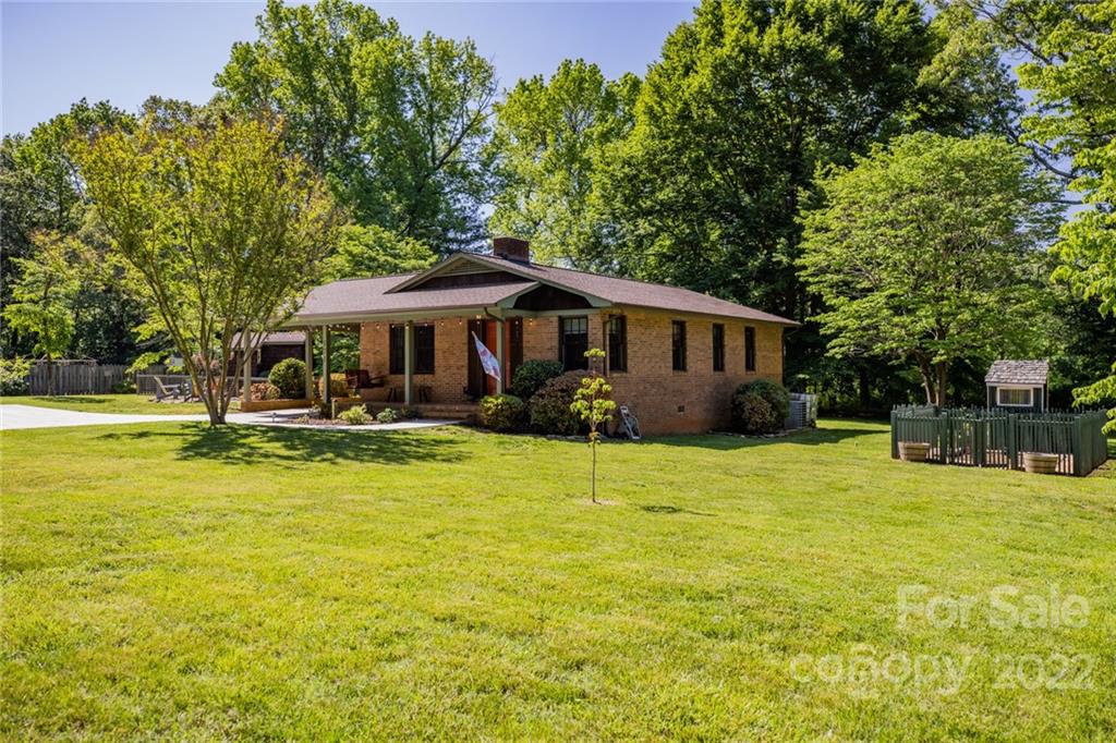 171 Orchard Road Statesville, NC 28677 - Photo 3 of 46 a view of a swimming pool with lawn chairs under an umbrella