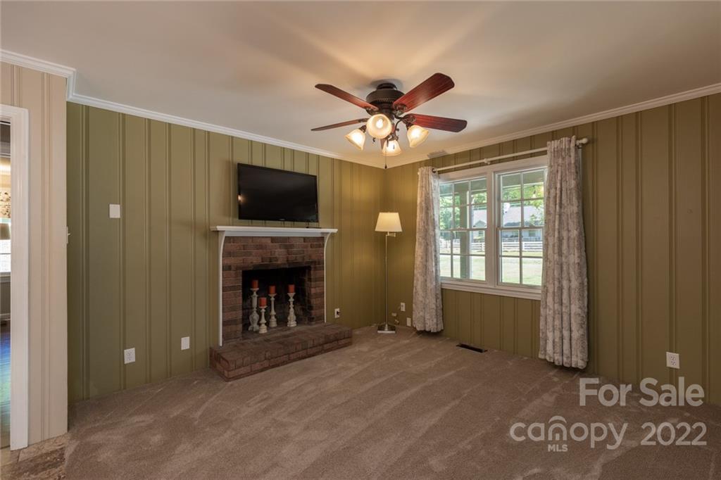 171 Orchard Road Statesville, NC 28677 - Photo 34 of 46 a living room with a fireplace and a flat screen tv