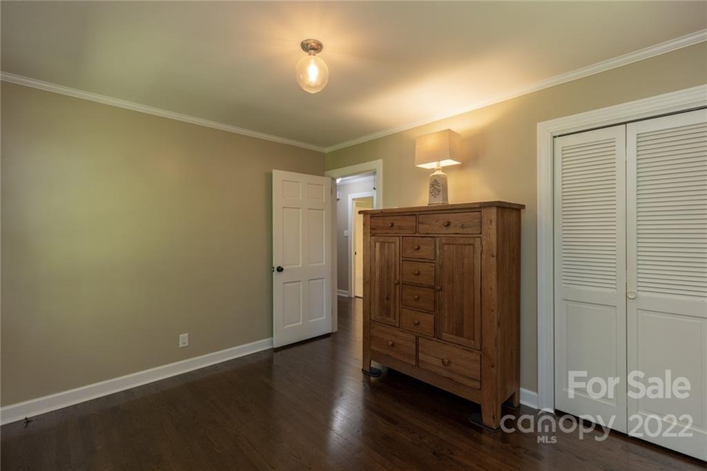 171 Orchard Road Statesville, NC 28677 - Photo 41 of 46 an empty room with wooden floor cabinet and windows
