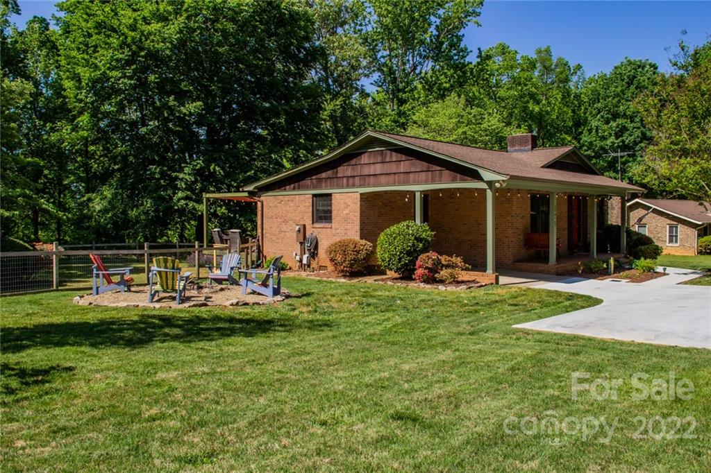 171 Orchard Road Statesville, NC 28677 - Photo 9 of 46 a view of a house with backyard sitting area and garden