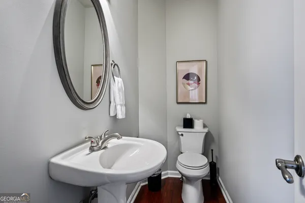 a bathroom with a sink mirror and toilet
