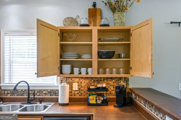 a kitchen with granite countertop a sink and a stove next to a window