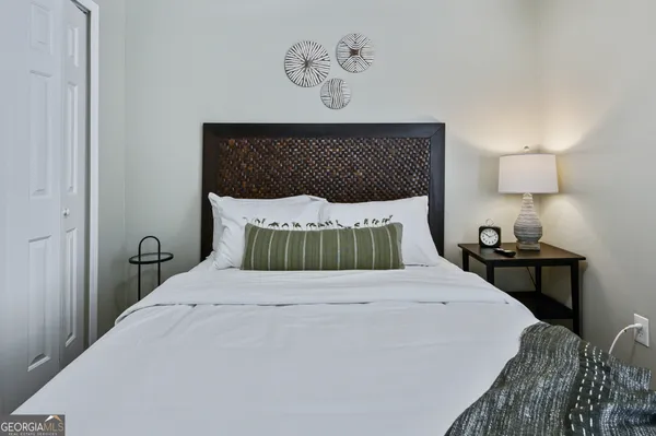 a bedroom with a bed and a lamp