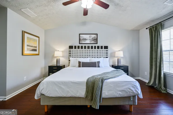 a bedroom with a bed and a window