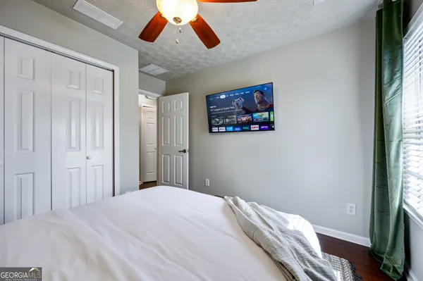 a bedroom with a bed and a large mirror