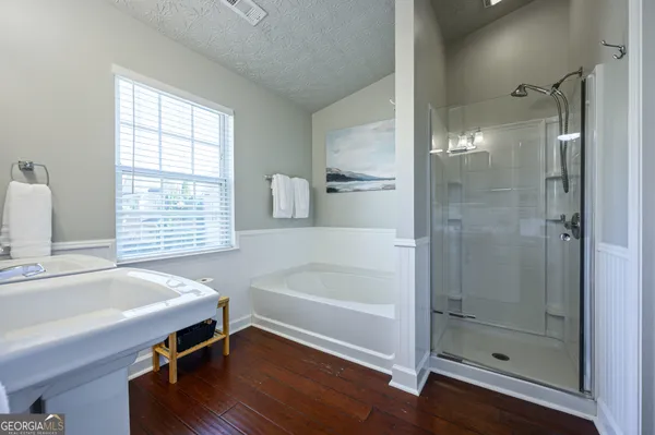 a bathroom with a tub and a sink
