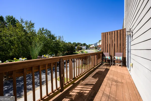 a view of balcony with wooden floor and fence