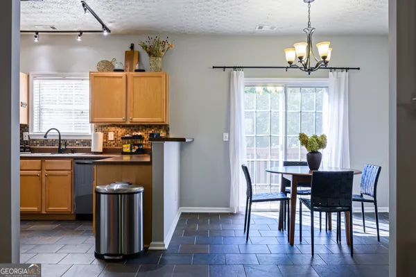 a kitchen with sink and cabinets