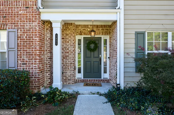 a front view of a house with a garden