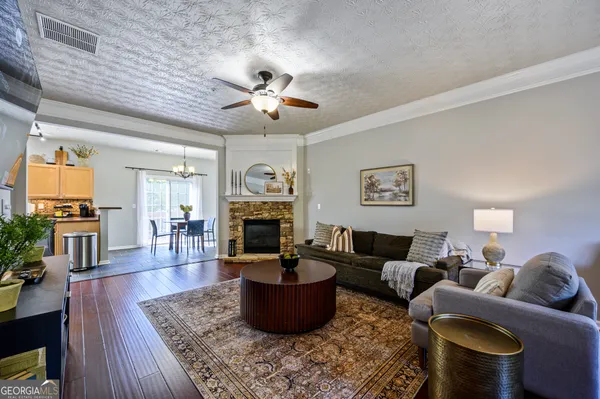 a living room with furniture a fireplace and a flat screen tv