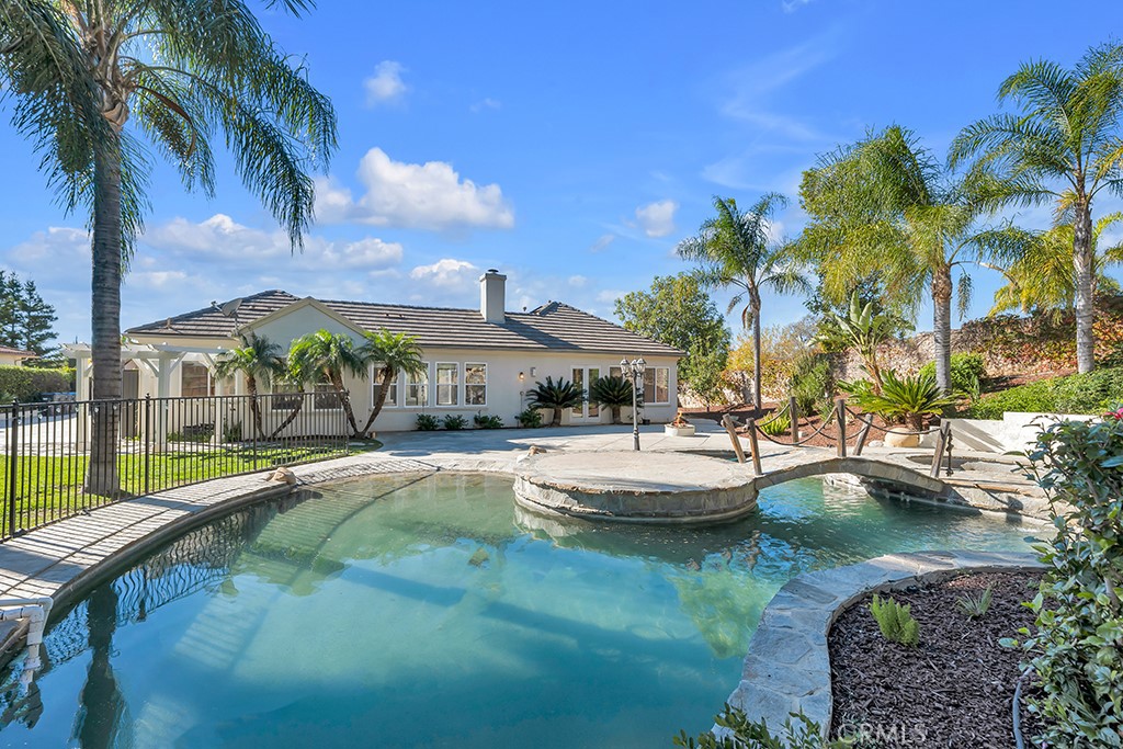 a view of swimming pool with outdoor seating and lake view