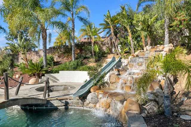 a backyard of a house with yard table and chairs