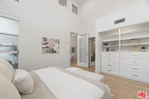 a bedroom with a bed and a cabinets