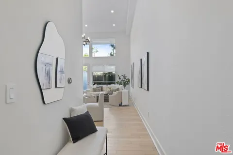 a living room with furniture a rug and a large mirror