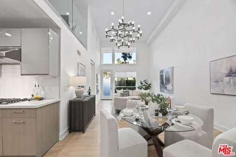 a dining room with furniture and chandelier