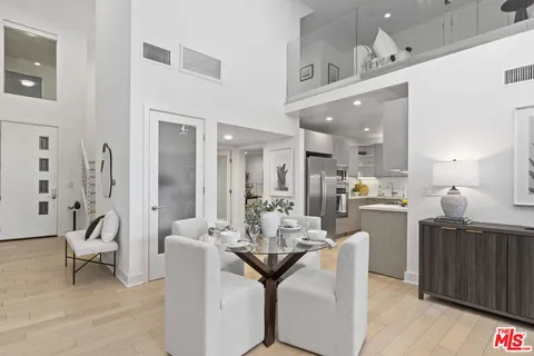 a living room with furniture and kitchen view