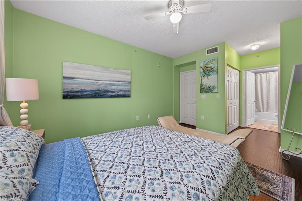 1105 Reserve Court, Unit 206 Naples, FL 34105 - Photo 8 of 23 a bedroom with a bed and a dresser
