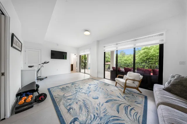 a bedroom with furniture and a large window