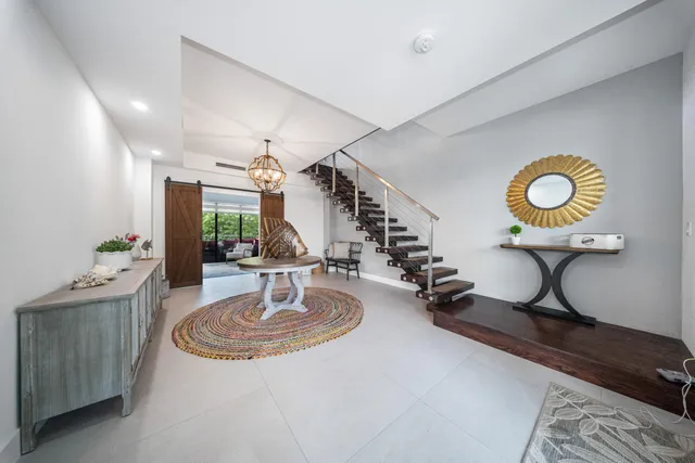 a living room with furniture and a mirror