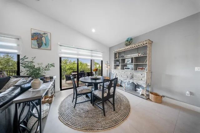 a living room with furniture a rug and a large window