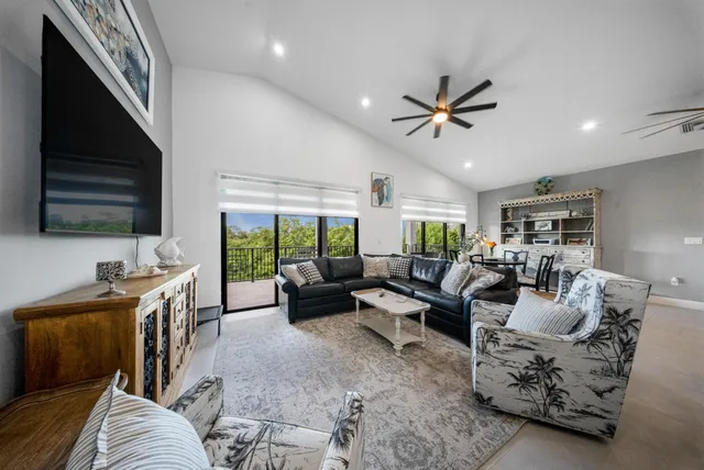 a living room with furniture ceiling fan and a rug