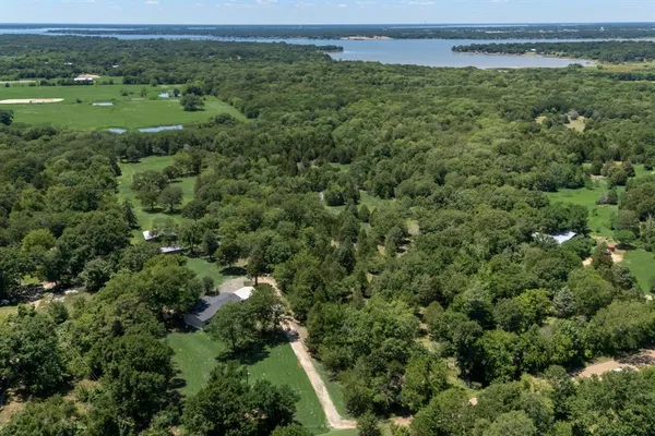 an aerial view of a houses with yard