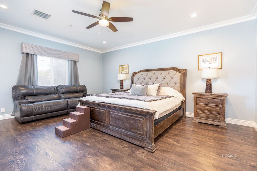 1030 Arroyo Street Ridgecrest, CA 93555 - Photo 17 of 49 a bedroom with a bed and a couch