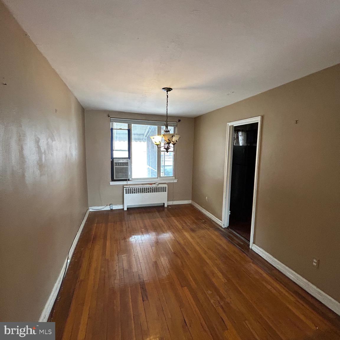6426 North Capitol Street Northwest Washington, DC 20012 - Photo 5 of 18 an empty room with wooden floor and windows