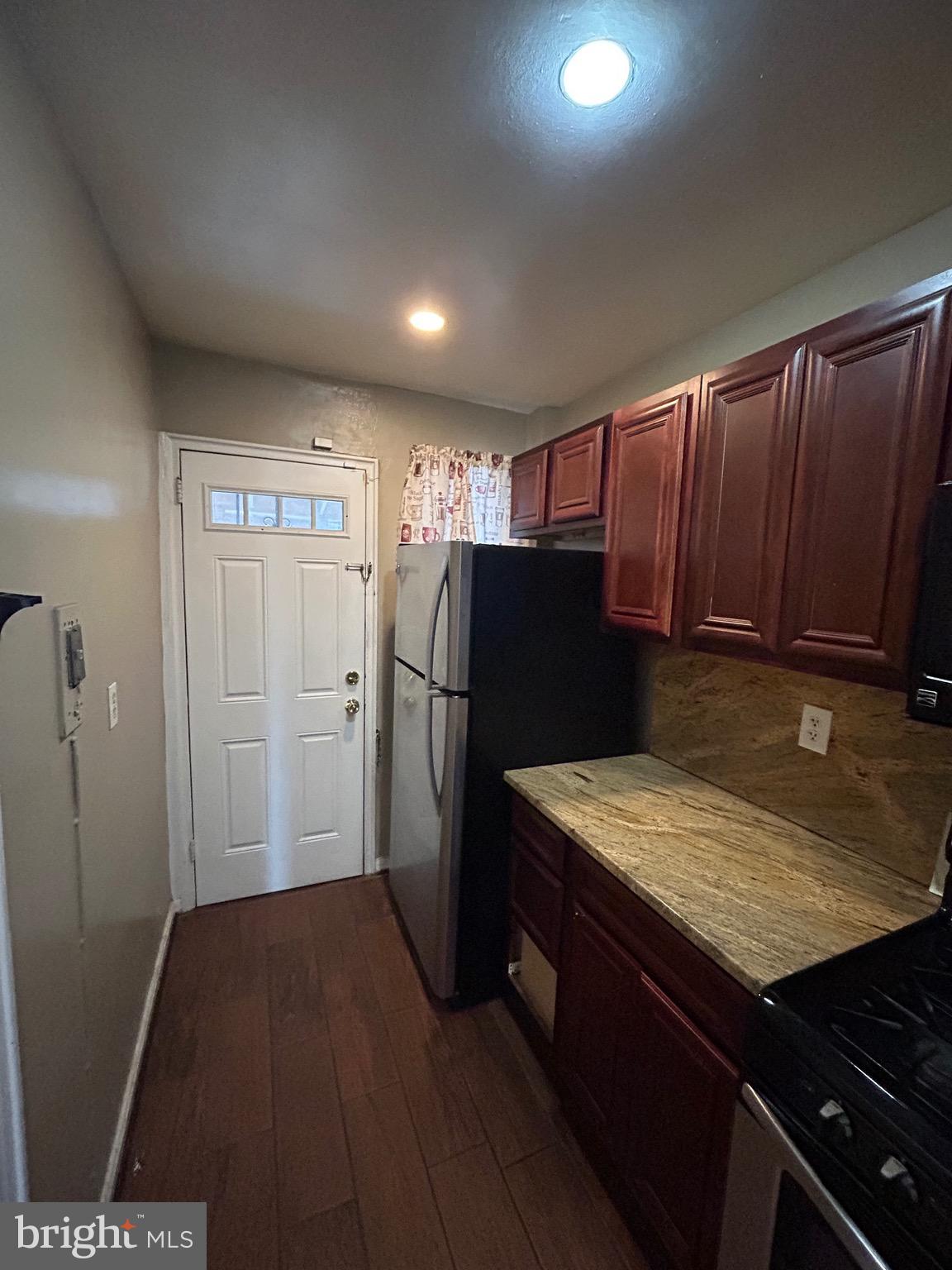 6426 North Capitol Street Northwest Washington, DC 20012 - Photo 7 of 18 a view of kitchen with refrigerator and wooden cabinets