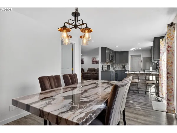 a view of a dining room with furniture and wooden floor