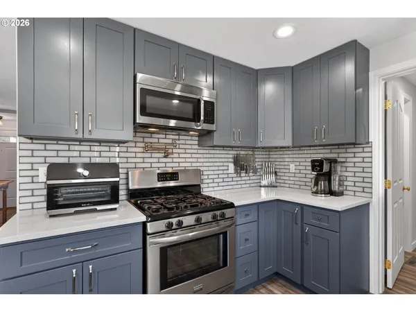 a kitchen with cabinets stainless steel appliances and wooden cabinets