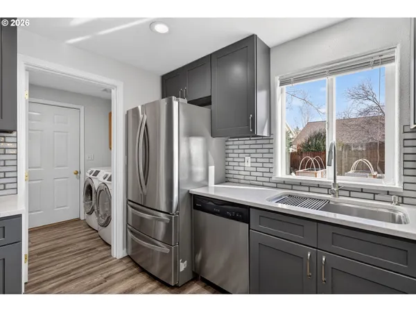 a kitchen with a refrigerator and a sink
