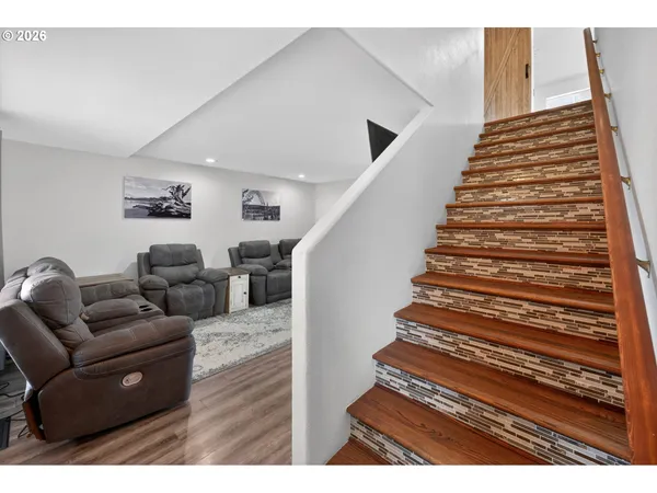 a living room with furniture and a stair