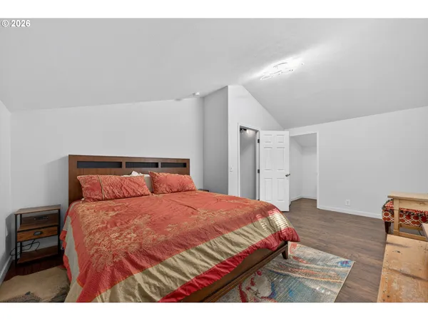 a bedroom with a bed and a night stand