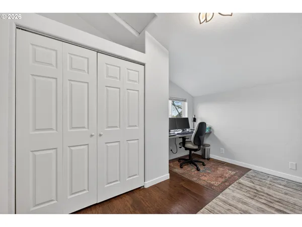 a view of a workspace with furniture and a window