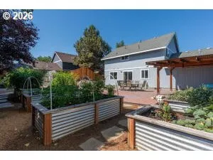 a view of a chair and tables in the back yard of the house