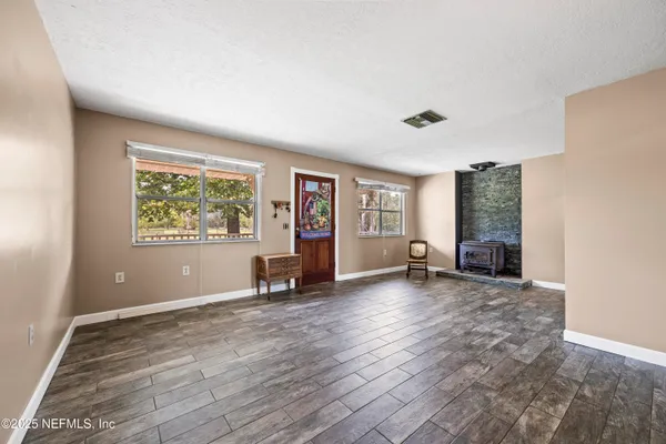 a view of a livingroom with furniture window and wooden floor