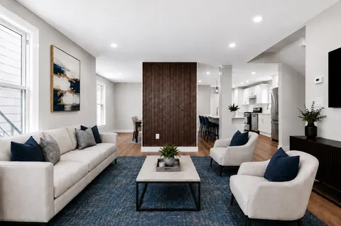 a living room with furniture and a large window