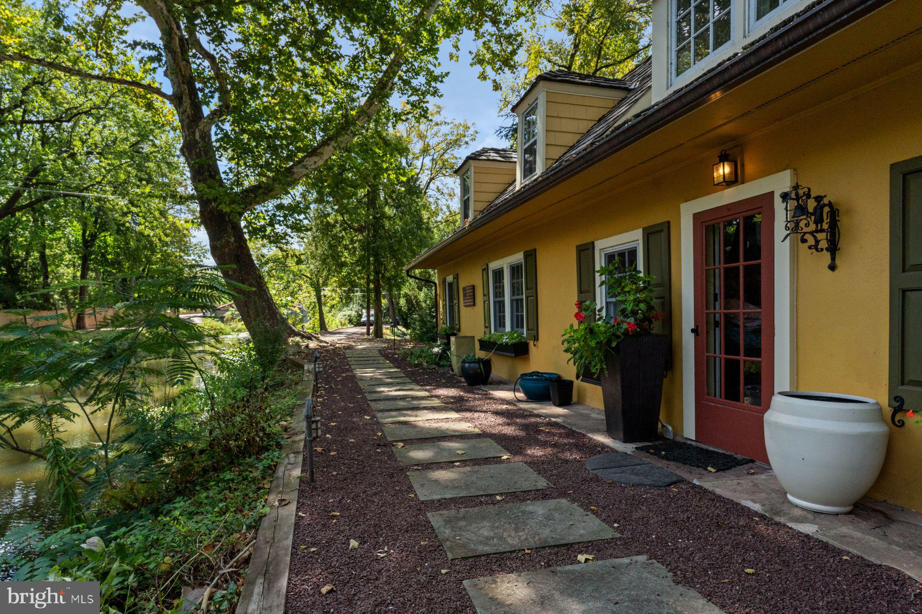 2472 River Road New Hope, PA 18938 - Photo 3 of 50 a view of a patio with table and chairs and potted plants