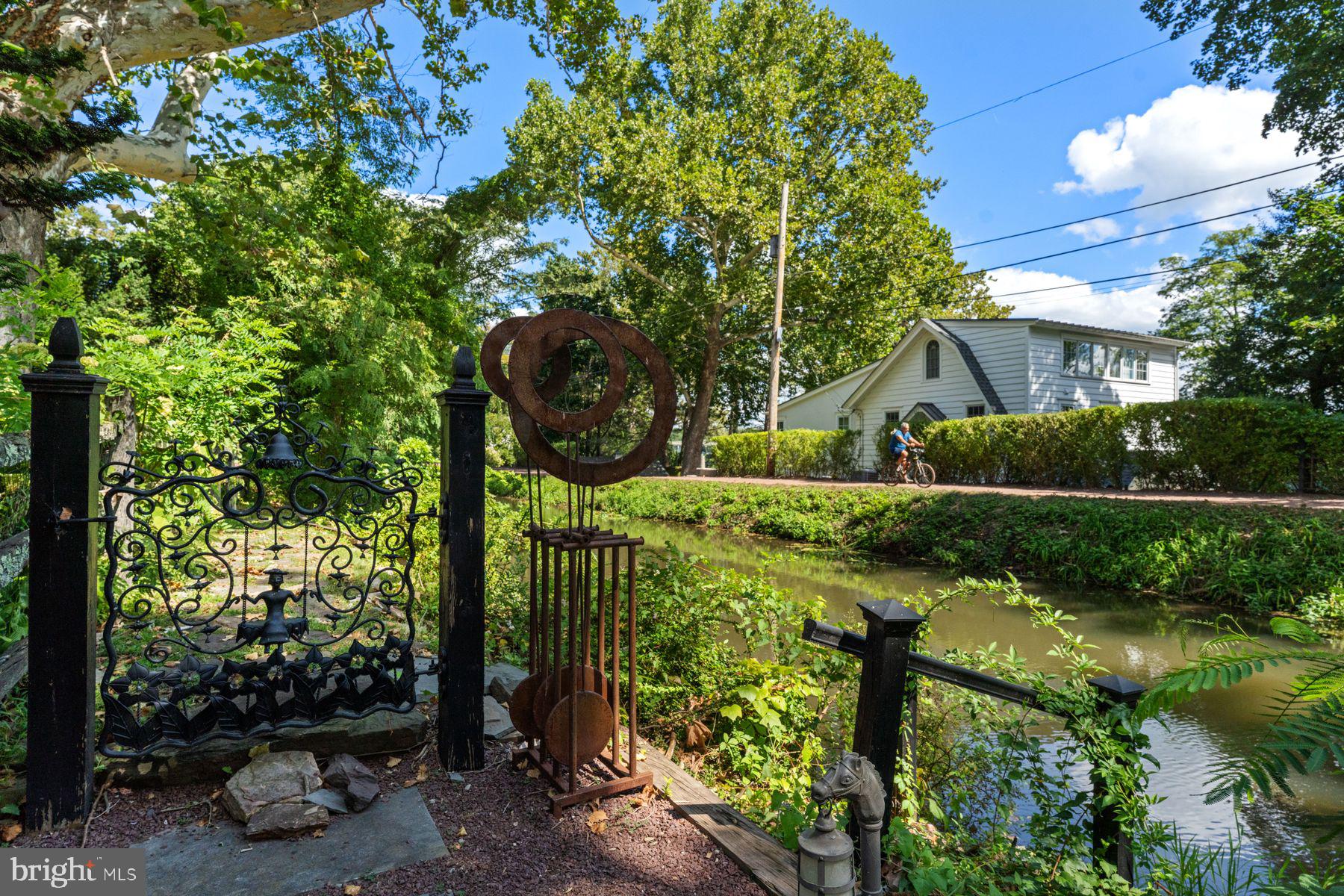 2472 River Road New Hope, PA 18938 - Photo 40 of 50 a view of a garden with plants and large trees