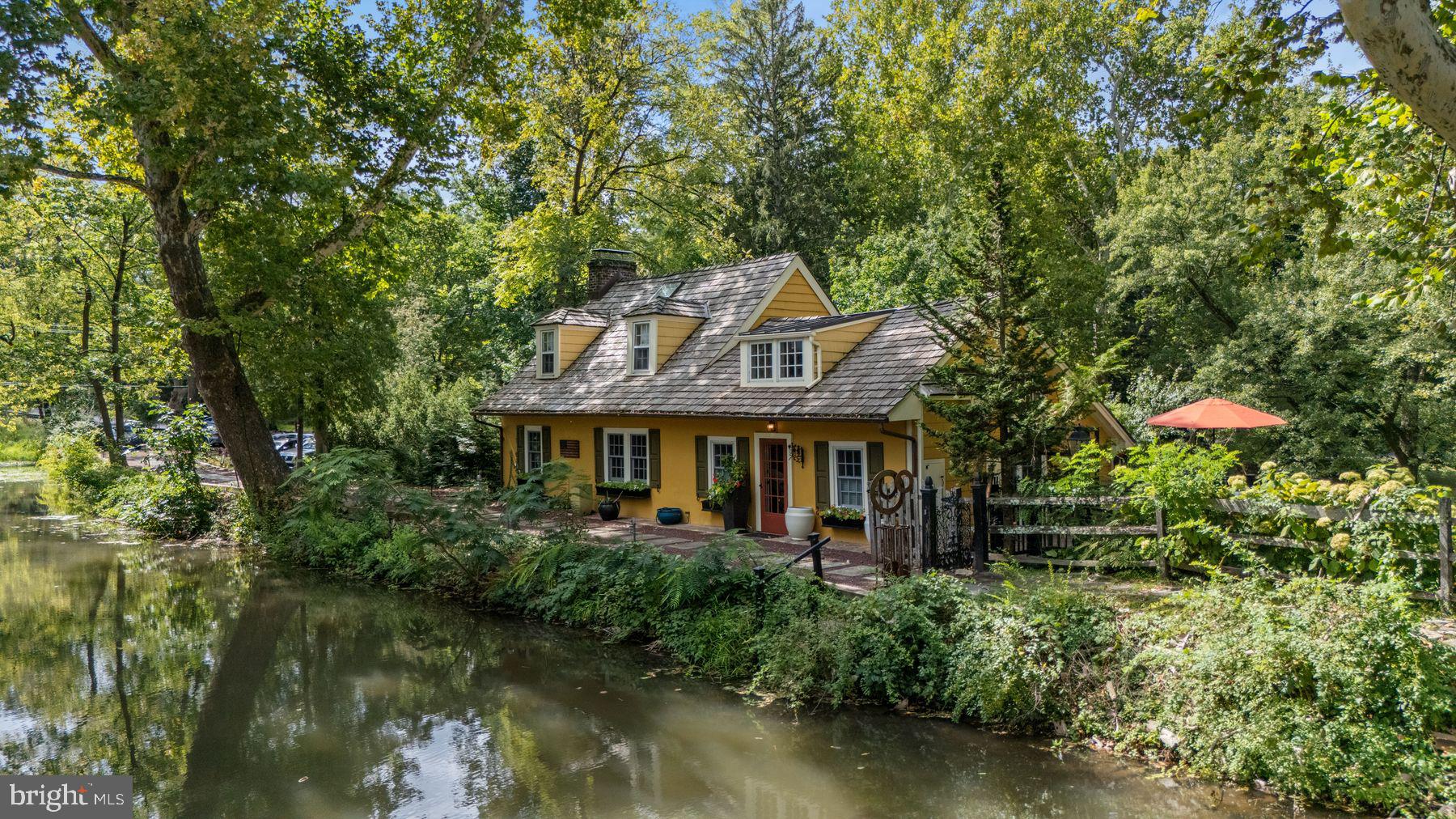 2472 River Road New Hope, PA 18938 - Photo 44 of 50 a view of a house with a large pool and a lawn chairs under an umbrella