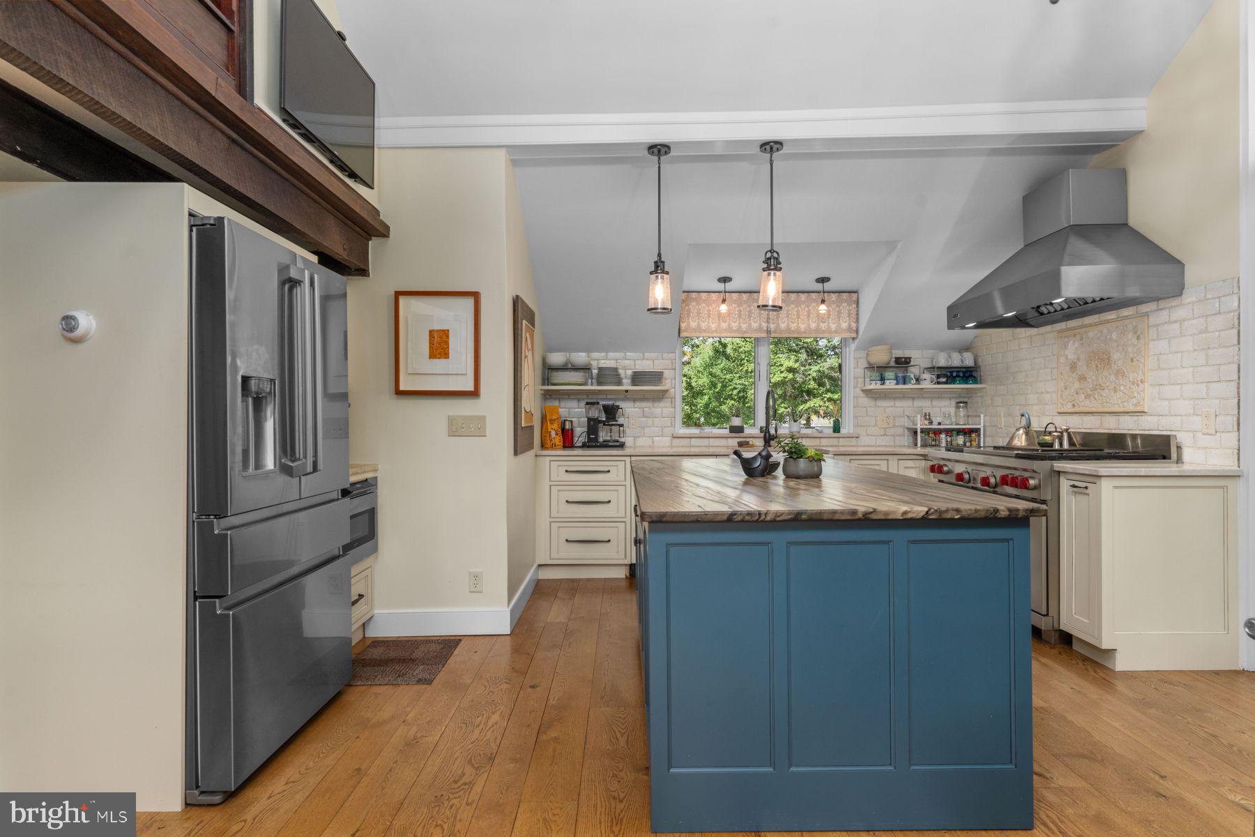 2472 River Road New Hope, PA 18938 - Photo 7 of 50 a kitchen with kitchen island granite countertop a refrigerator a stove a sink and a dining table