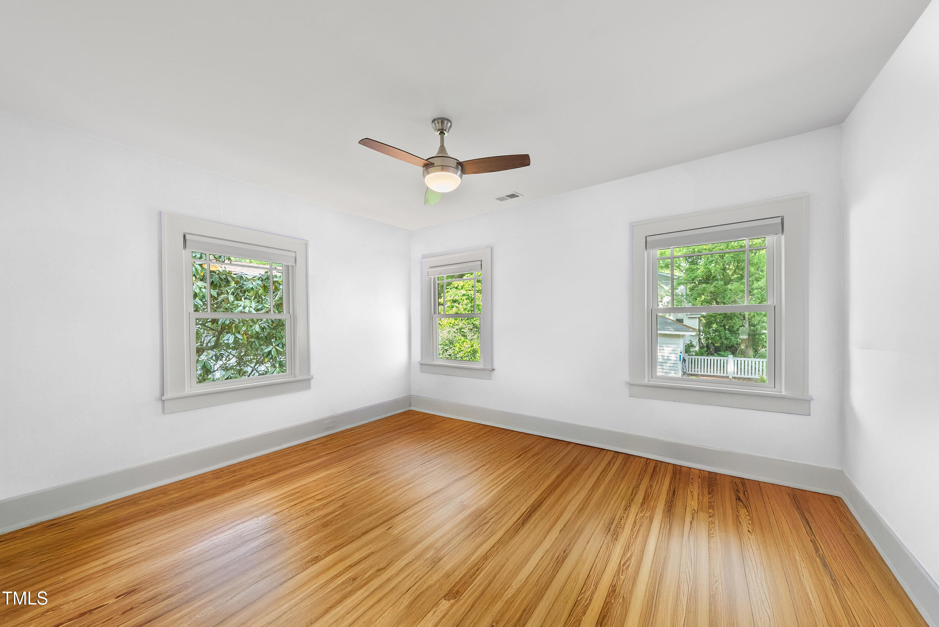 223 Hawthorne Road Raleigh, NC 27605 - Photo 29 of 47 wooden floor in an empty room with a window