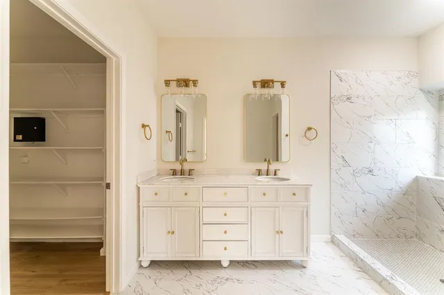 a bathroom with a double vanity sink and mirror