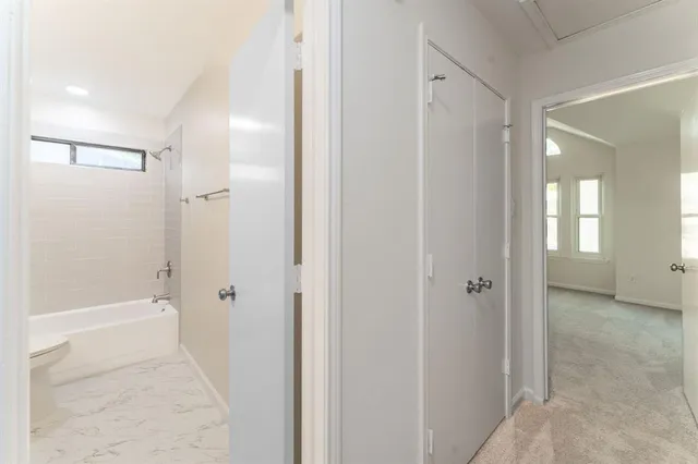 a bathroom with a bathtub and shower