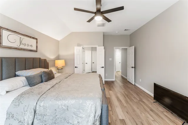 a bedroom with bed and a chandelier