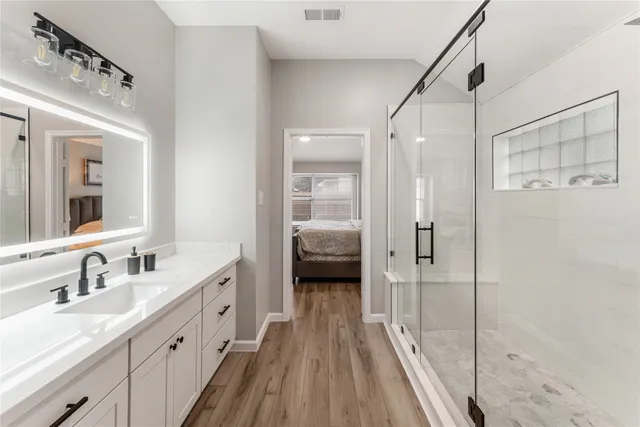 a bathroom with a double vanity sink and mirror