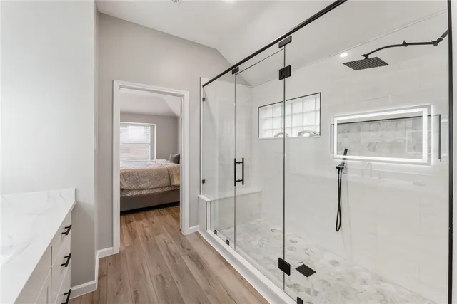 a bathroom with a tub and shower